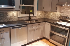 Kitchen grey cabinets with dark counter-tops